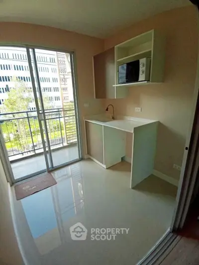 Modern kitchen with open layout and balcony view in urban apartment