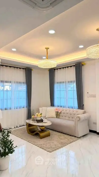 Elegant living room with plush sofa, modern lighting, and chic decor in a stylish home.