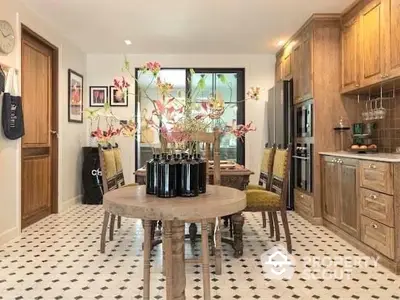 Charming kitchen with a rustic wooden dining set, patterned floor tiles, and ample cabinetry, creating a warm, inviting space for family meals.