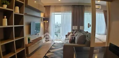 Modern living room with cozy sofa and city view, perfect for relaxation and entertainment.
