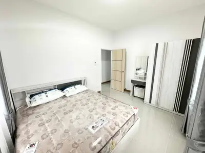 Spacious bedroom with modern furniture and ample natural light