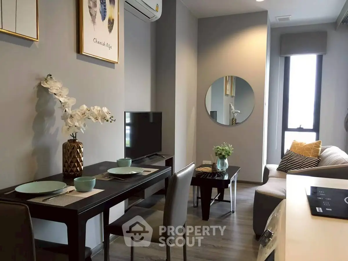 Modern living room with stylish decor and dining area in a cozy apartment.