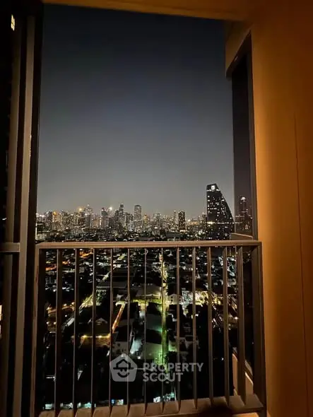 Stunning city skyline view from a high-rise balcony at night, perfect for urban living enthusiasts.