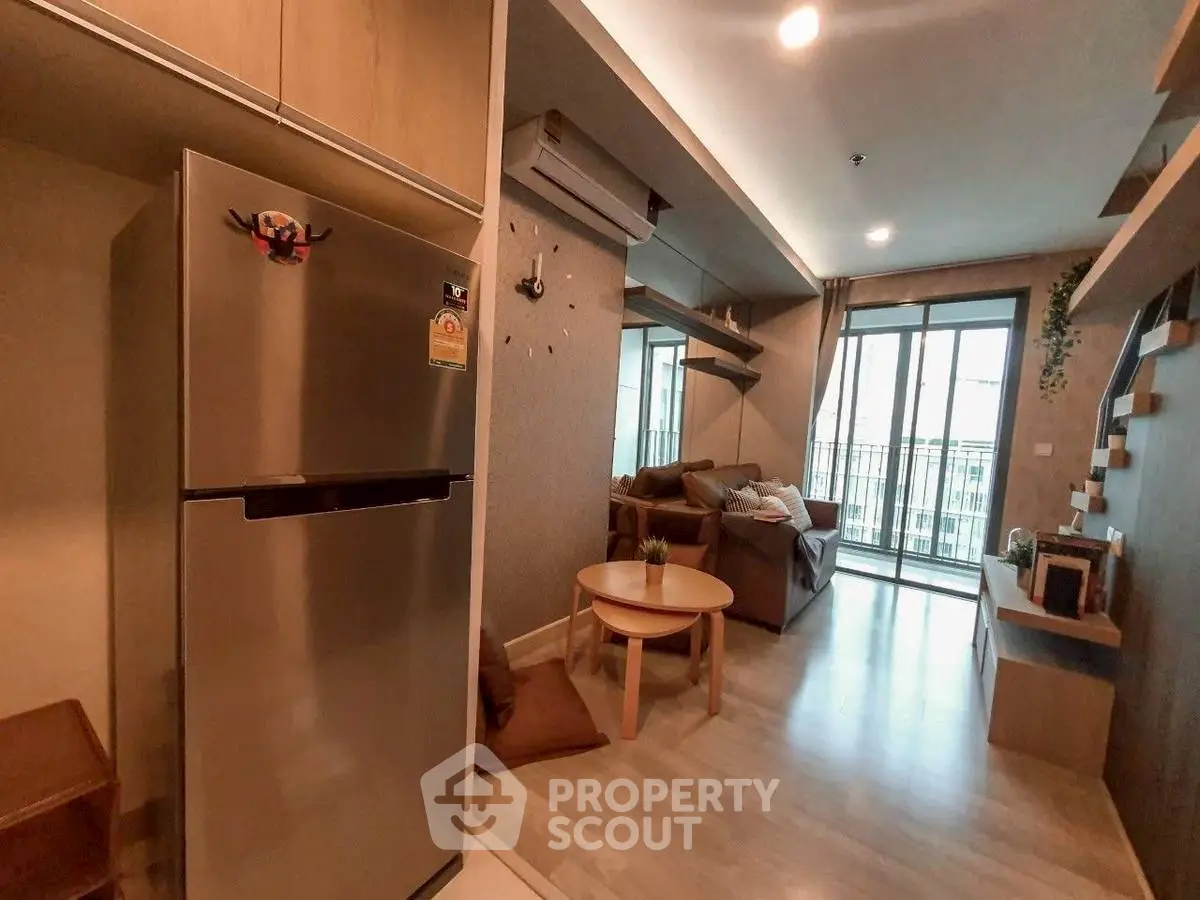Modern living room with open kitchen and balcony view in stylish apartment