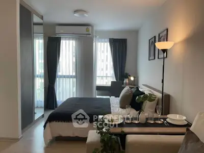 Modern bedroom with stylish decor and natural light in a cozy apartment setting.