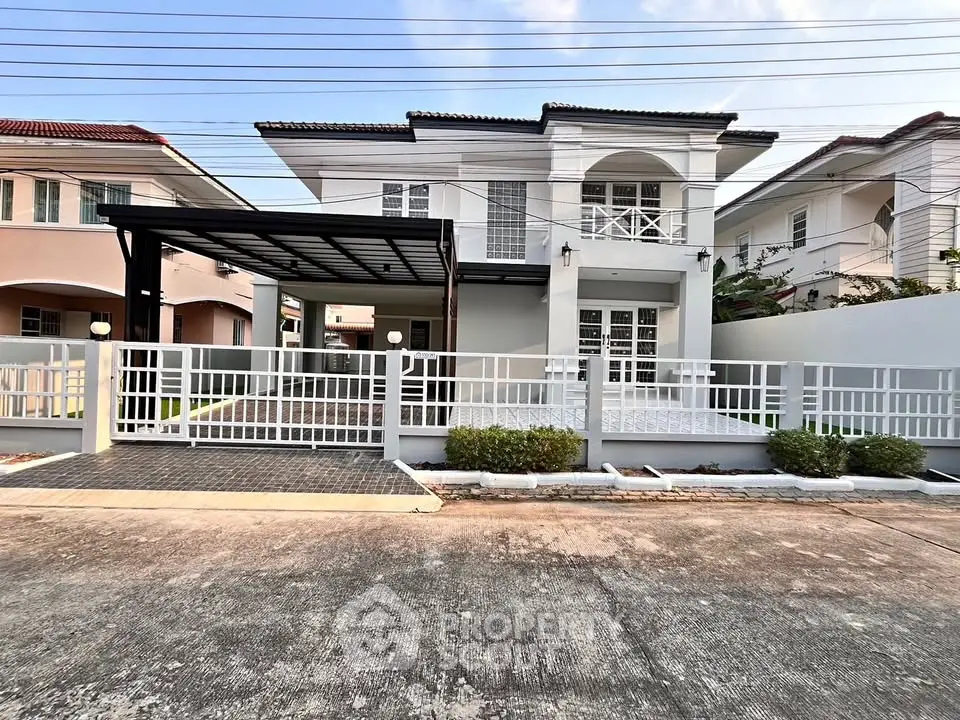 Elegant two-story house with modern facade and spacious driveway in a serene neighborhood.