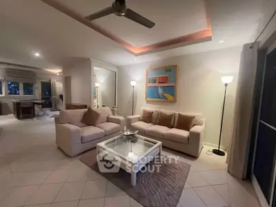 Spacious living room with modern decor and cozy seating in a stylish home.