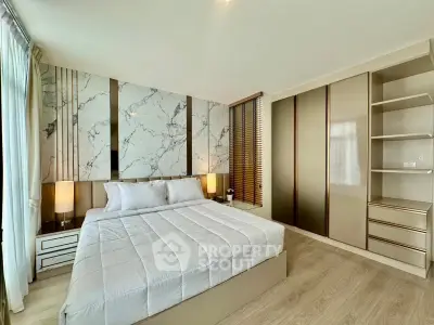 Luxurious bedroom with modern decor and elegant marble accent wall