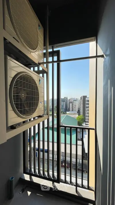 Urban balcony with city view and air conditioning units, perfect for modern living.