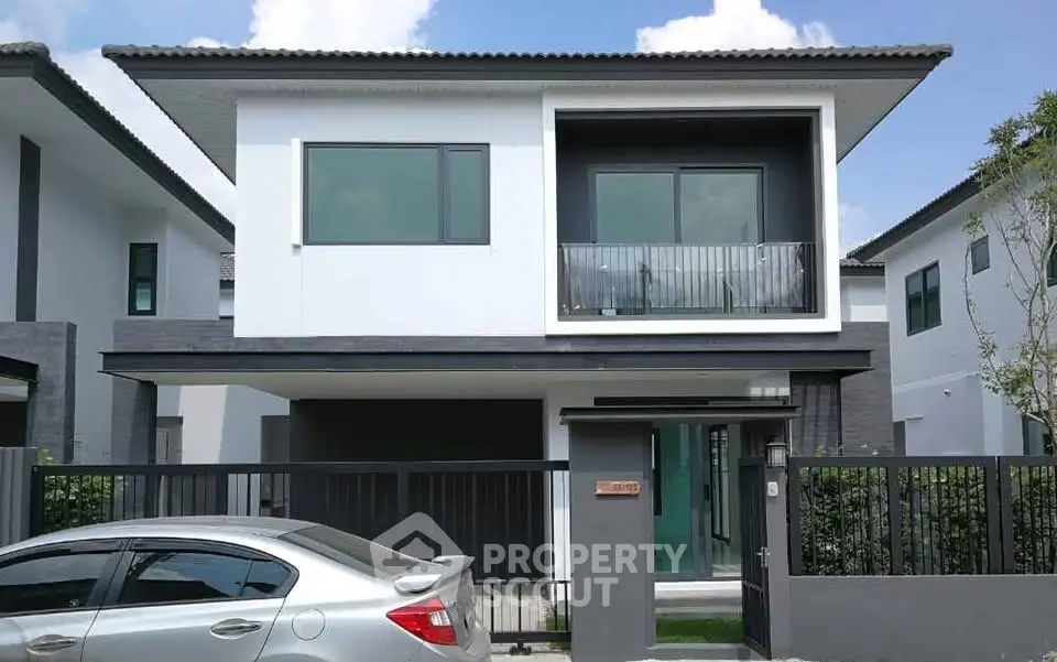 Modern two-story house with sleek design and large windows, perfect for contemporary living.