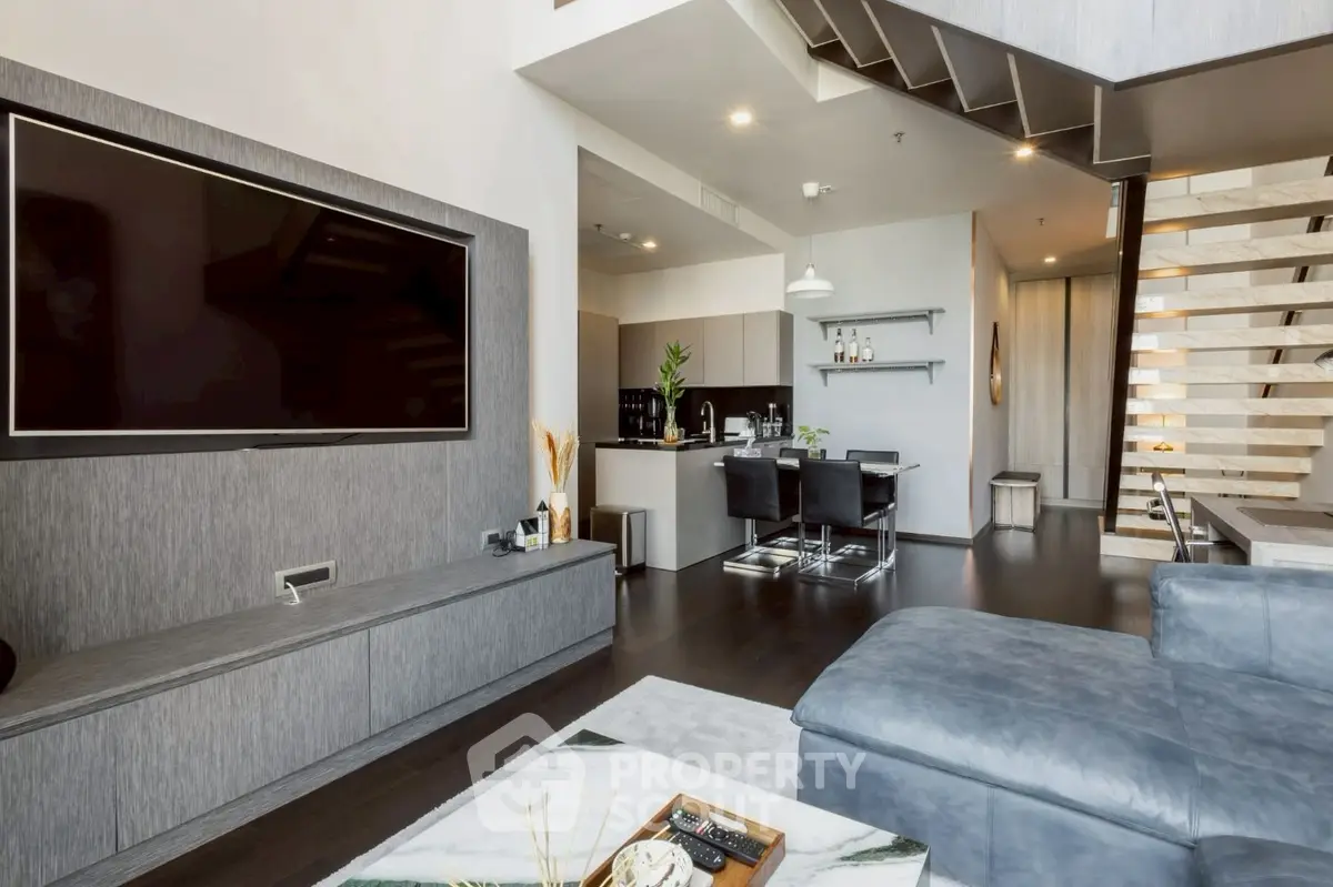 Modern living room with sleek design and open kitchen layout
