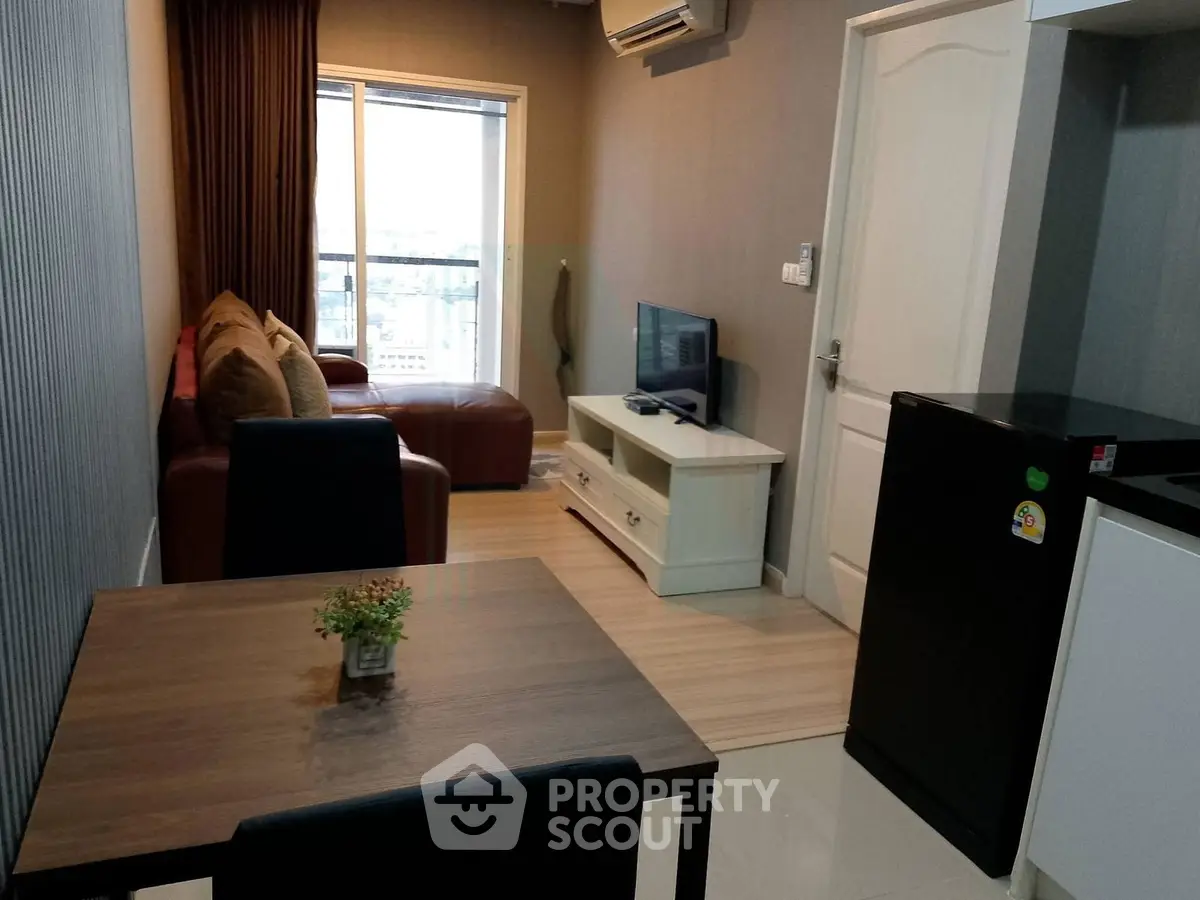 Modern living room with cozy seating and city view, perfect for urban living.