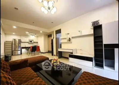 Spacious modern living room with open kitchen and stylish furniture in a contemporary apartment.
