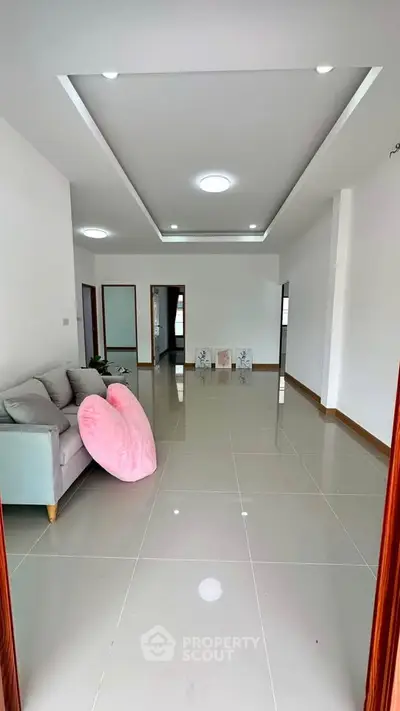 Spacious modern living room with sleek tile flooring and stylish decor