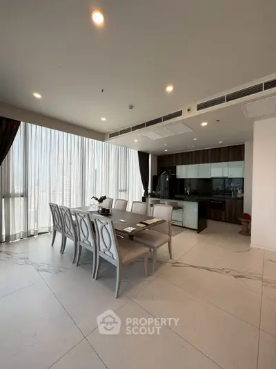 Spacious modern dining area with elegant furniture and open kitchen layout in luxury apartment.