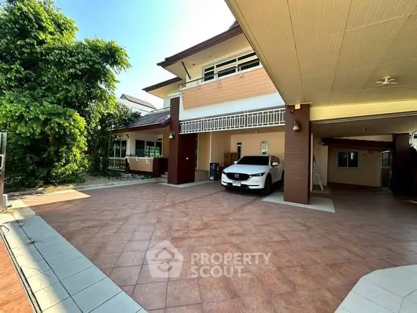 Spacious residential property with covered parking and lush greenery