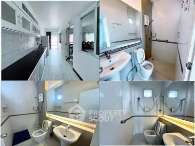 Spacious bathroom with modern fixtures and sleek kitchen in a well-lit apartment.