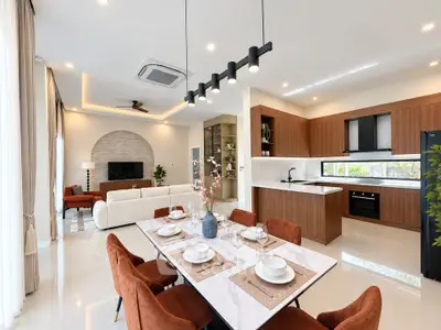 Luxurious open-plan living and dining area with modern kitchen and elegant decor.