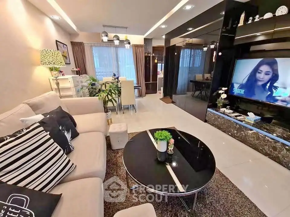Spacious modern living room with elegant decor and open dining area, perfect for entertaining.