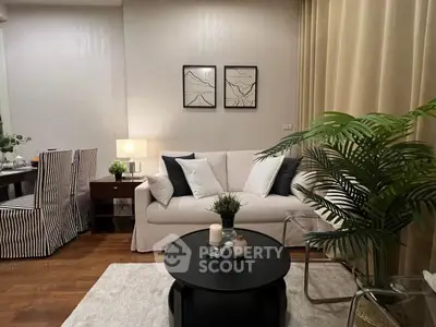 Stylish living room with cozy sofa, elegant decor, and warm lighting for a welcoming ambiance.