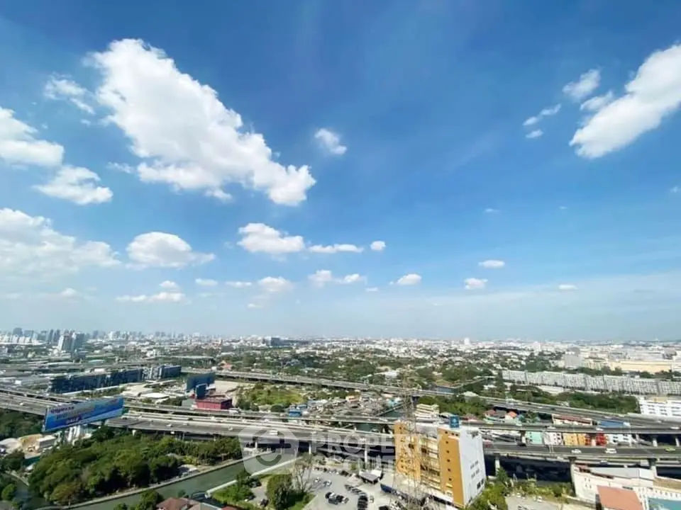 Stunning panoramic cityscape view with clear blue skies and urban landscape.