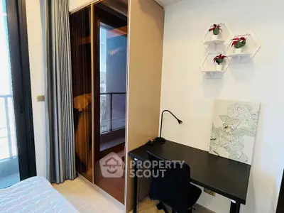 Modern bedroom with sleek desk and stylish wall decor