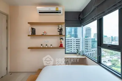 Modern bedroom with large windows and city view, featuring stylish shelves and air conditioning.