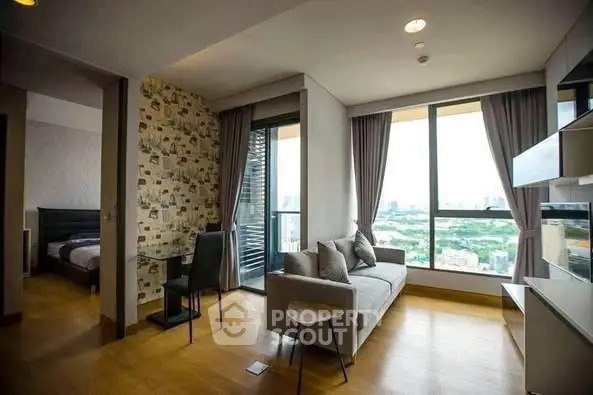 Modern living room with large windows and city view, adjacent to a cozy bedroom.