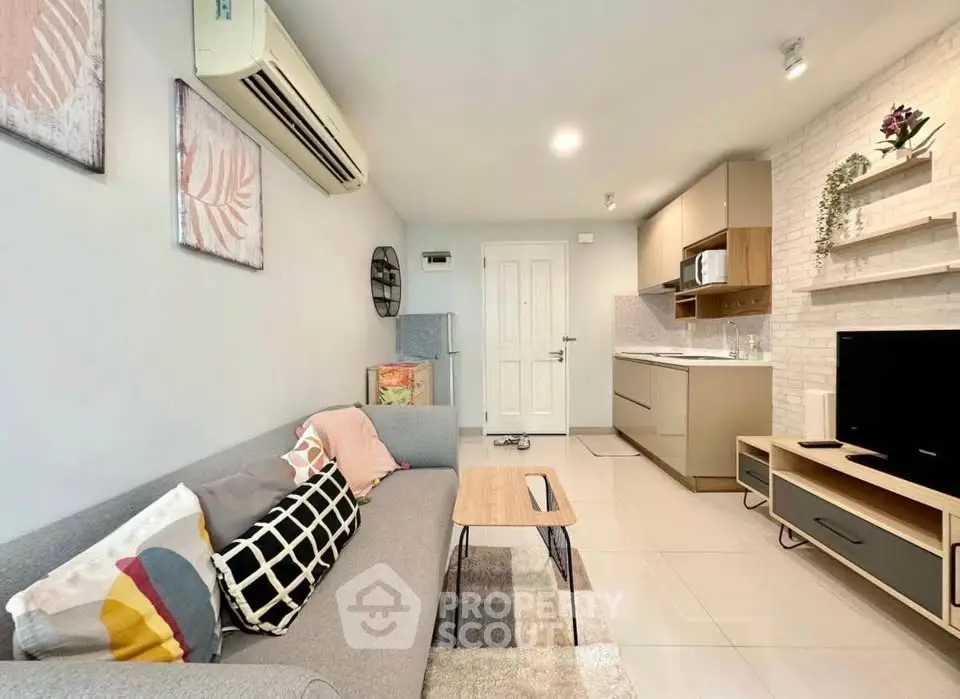 Modern living room with stylish decor and open kitchen layout in a cozy apartment.