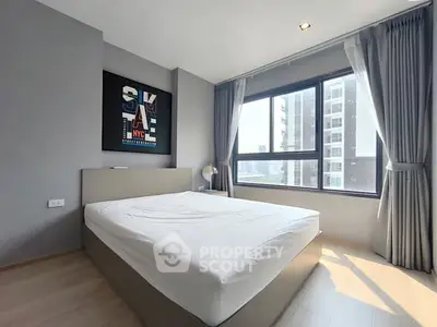 Modern bedroom with large window and stylish decor in urban apartment