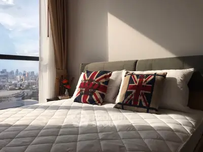 Modern bedroom with city view and stylish decor pillows