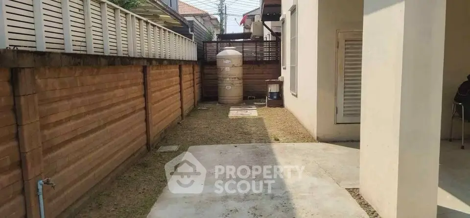 Spacious backyard with utility area and privacy fencing in suburban home