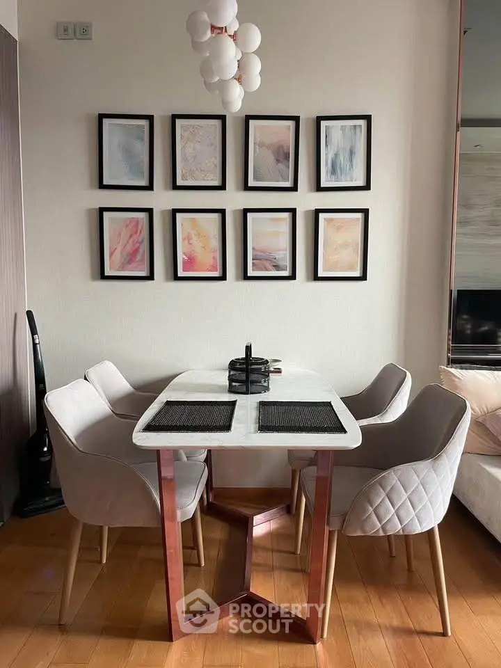Stylish dining area with modern table and chairs, elegant wall art, and cozy ambiance.