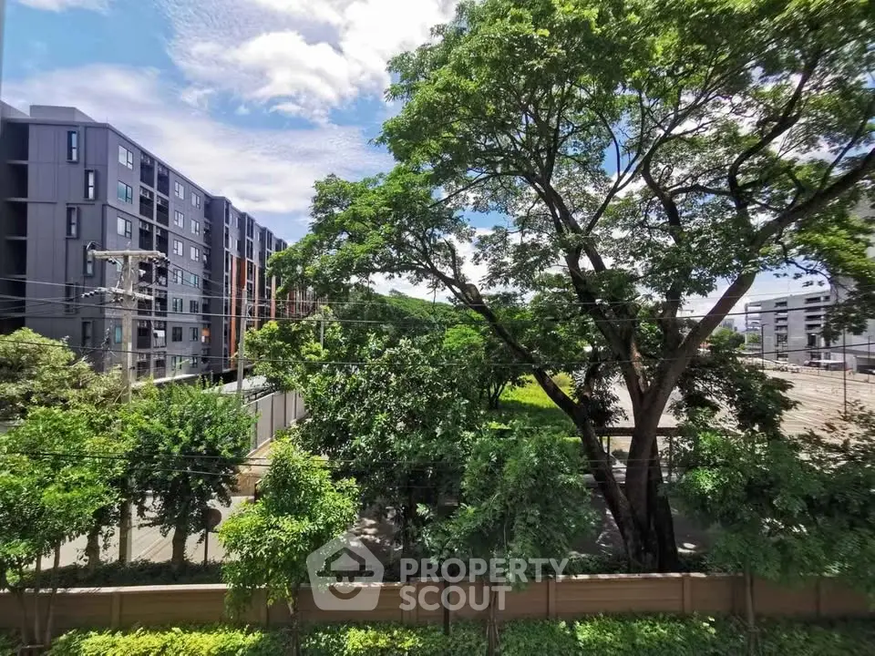 Modern apartment building with lush greenery and clear blue sky view