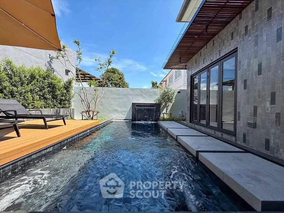 Luxurious modern home with private pool and elegant patio area.