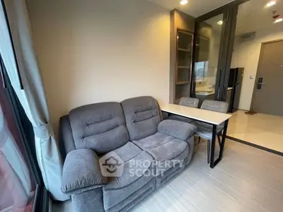 Cozy living room with plush sofa and modern decor in a stylish apartment.