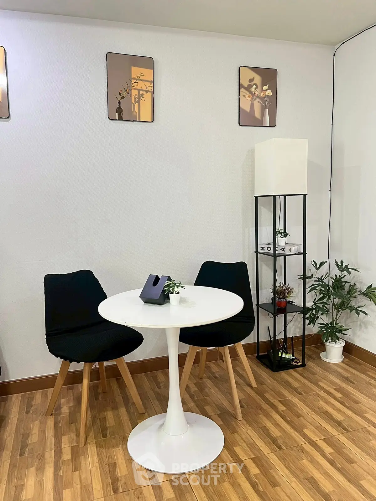 Cozy modern dining nook with stylish chairs and round table, perfect for intimate meals.