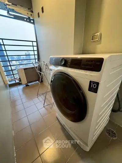 Modern apartment balcony with washing machine and city view