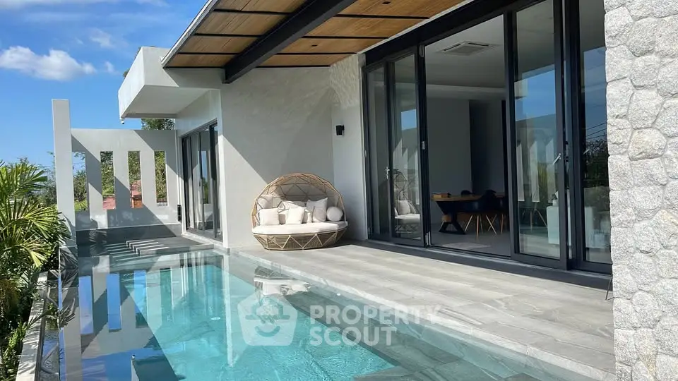 Luxurious modern villa with private pool and stylish outdoor seating area, perfect for relaxation and entertainment.