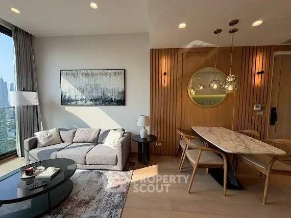 Modern living room with stylish decor and city view, featuring a cozy sofa and elegant dining area.
