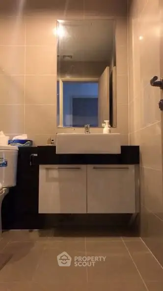 Modern bathroom with sleek fixtures and large mirror