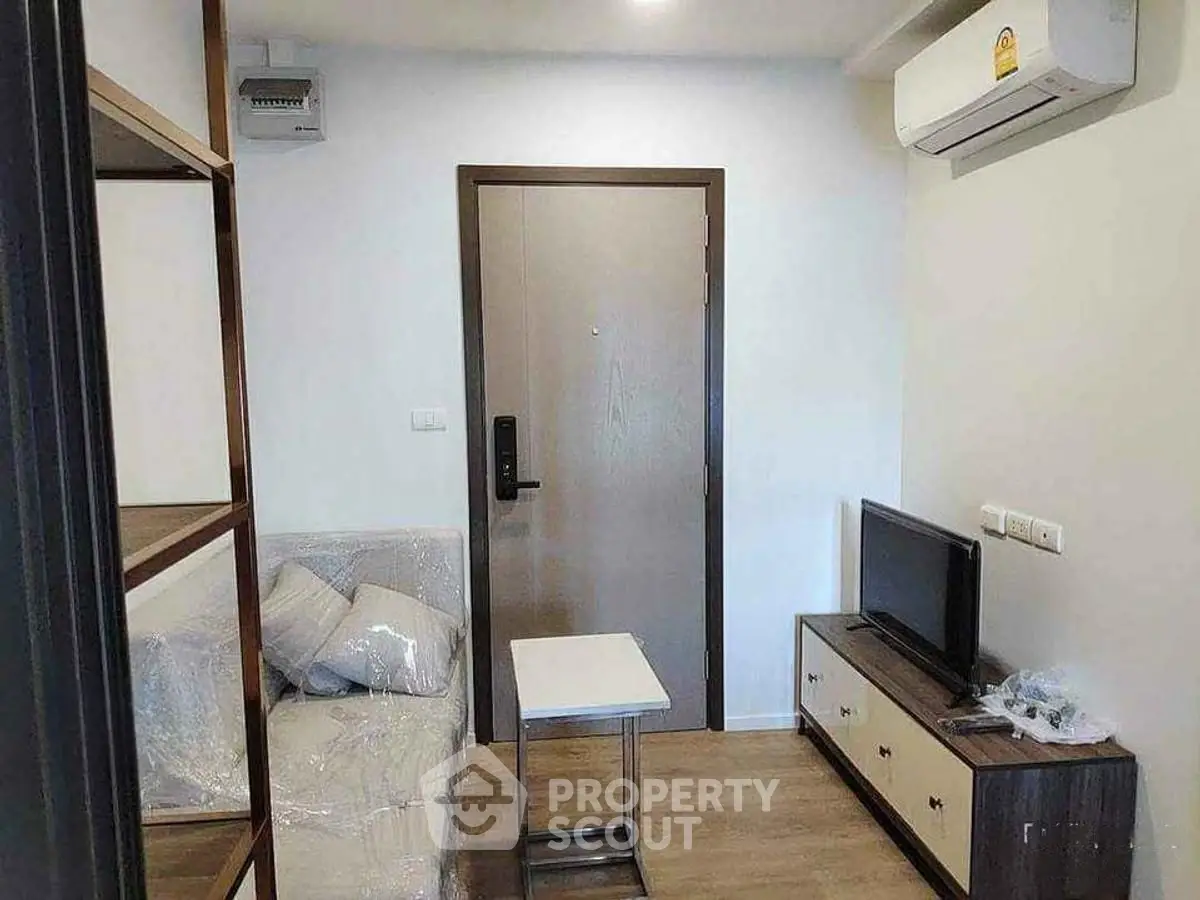 Cozy living room with modern furniture and air conditioning in a compact apartment.