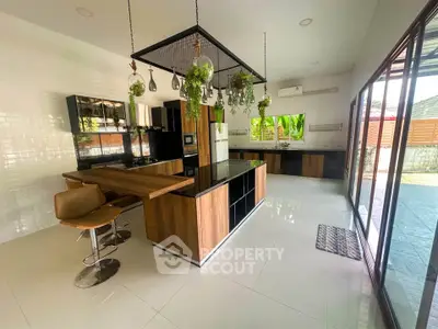 Spacious modern kitchen with open layout and stylish island, featuring sleek cabinetry and large windows for natural light.
