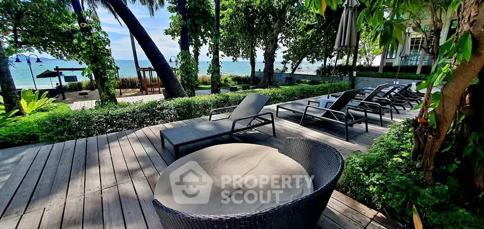 Luxurious beachfront property with stunning ocean views and lush greenery, perfect for relaxation and leisure.