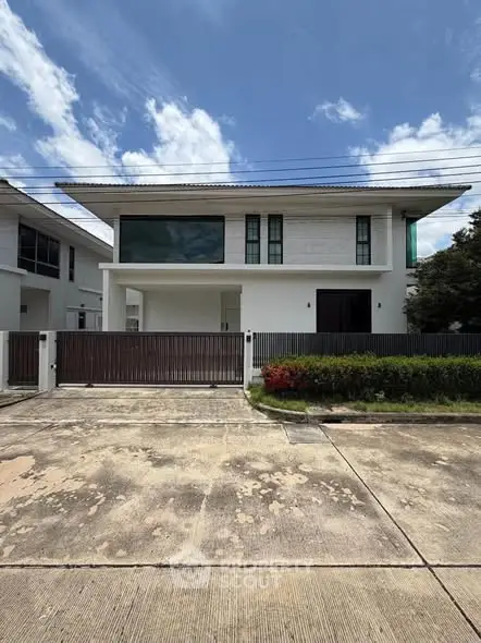 Modern two-story house with sleek design and spacious driveway in a serene neighborhood.