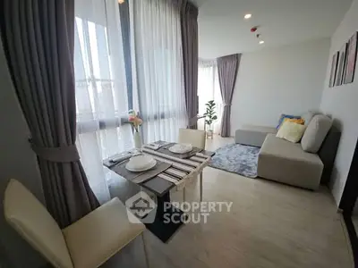 Modern living room with elegant dining setup and cozy seating area