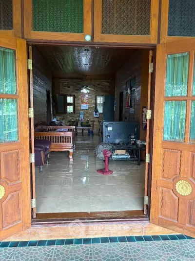 Charming wooden living room with open doors and cozy seating area