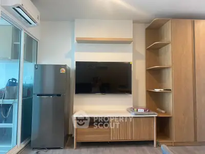 Modern living room with sleek TV unit and stainless steel fridge