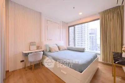 Modern bedroom with large window and stylish decor in urban apartment.