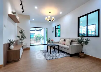 Modern living room with elegant decor and large windows offering natural light.